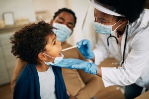 Child with doctor and parent at well-child visit