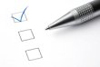 pen resting next to a checklist with one box checked off